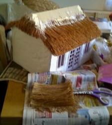 Toy house with straw roof made of coconut fiber