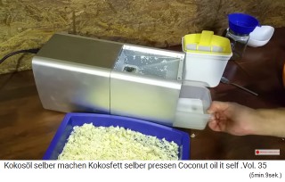 The oil bowl with the coconut oil is pulled out of the mill
