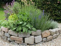 dry stone wall around flower bed herbal
                spiral is VERY GOOD