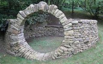 Dry stone wall marks a
                          courtyard at the edge of a forest