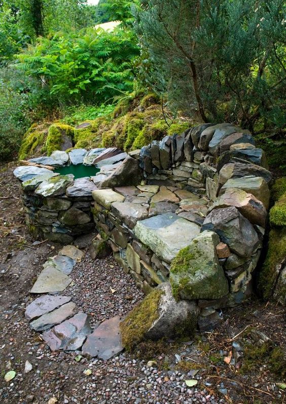 Dry wall art: a stone
                    sofa and a watering place in the wild garden
