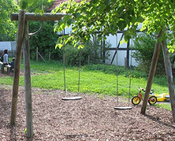 Group of swings with swings in
                                different heights and with a woodchip
                                surface, Heiningen near Stuttgart,
                                Germany