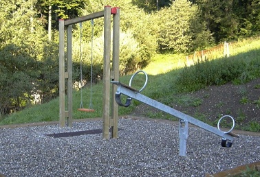 Boring surrounding with
                            a seesaw and a swing, Buochs, Switzerland