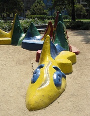 Fantasy 02: a volcano snake as a
                                bench around a palm tree in Brazil Park
                                (parque Brasil) in Santiago in Chile