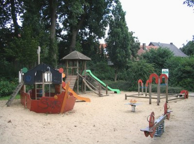 Playground at
                            Wilhelm Busch Street in Ibbenbueren
                            (Germany) with a ship with a slide, with a
                            little castle element with a second slide,
                            with spring riders and sand box