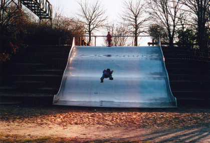 Broad wave
                                        slide passing a stairs at the
                                        border of a playground near a
                                        channel in Berlin Treptow
