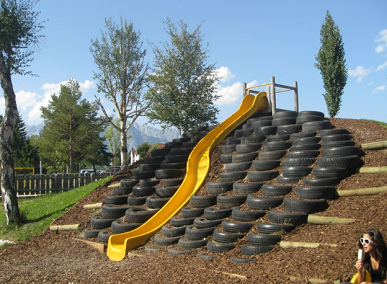 Curved slide on a slope with tire steps
                            on a woodchip ground, Seefeld in Tirol,
                            Austria