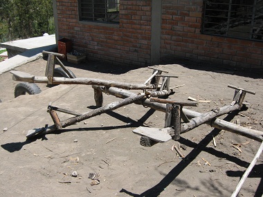 Seesaws made of wood without soft
                                rubber buffer, one of them is broken,
                                school Kitawa in Salasaca in Ecuador