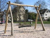 Long swing
                            03 with a trunk of wood with many ropes,
                            with a sandy soil, in Hebsacker in Emsland
                            in Germany