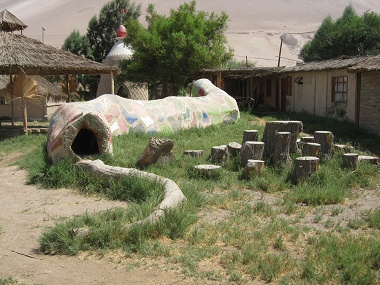 Playground snake 03 made of a trunk,
                              back view, on Hari Krishna farm "Eco
                              Truly" in Lluta Valley near Arica in
                              Chile